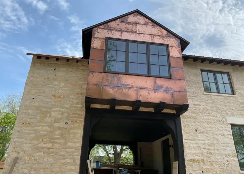 Copper metal panel facade on a stone building for Metal Roof Coating in Sachse